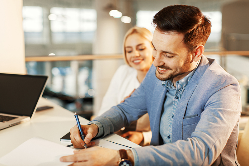 A client at The Rodgers Law Firm confidently signing documents with professional guidance, emphasizing personalized legal services in North Carolina.